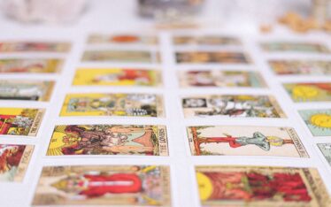 Vibrant spread of tarot cards laid out for an insightful reading session, showcasing various classic tarot designs.