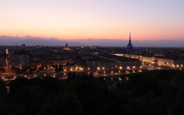 Captivating view of Turin's skyline at twilight featuring the iconic Mole Antonelliana.