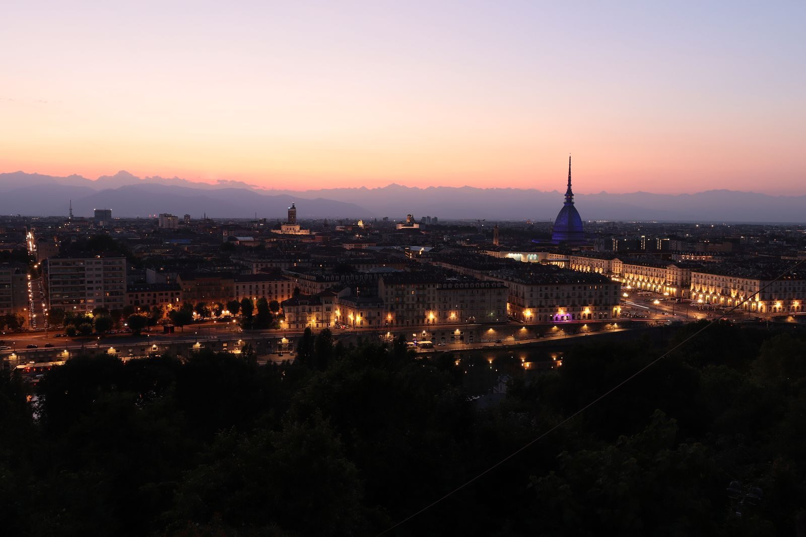 Captivating view of Turin's skyline at twilight featuring the iconic Mole Antonelliana.