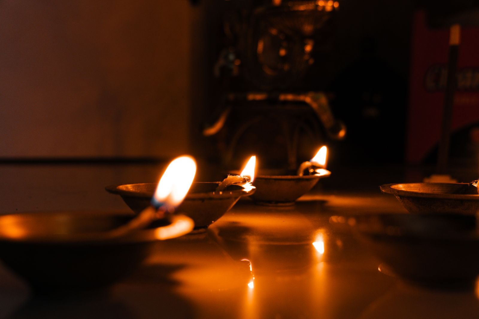 Close-up of traditional diyas lit for Diwali celebration in India, showcasing cultural heritage and warm ambiance.